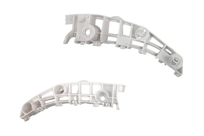 Two white molded plastic automotive or appliance trim pieces with integrated mounting holes and structural ribs, shown on a plain white background.